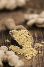 Portion of healthy Ground Ginger on an old wooden table (selective focus, close-up shot)