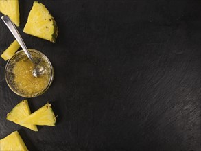 Portion of Pineapple Jam as detailed close up shot on a slate slab, selective focus