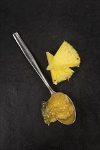 Portion of Pineapple Jam on a rustic slate slab, selective focus, close-up shot