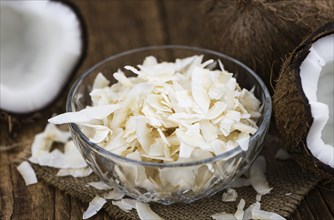 Coconut Chips (fresh) as detailed close-up shot, selective focus)