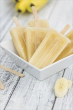 Banana Popsicles on vintage background as detailed close-up shot (selective focus)