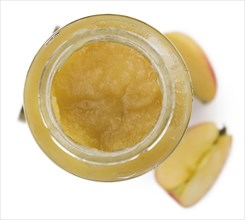 Portion of homemade Applesauce (selective focus) isolated on white background (close-up shot)