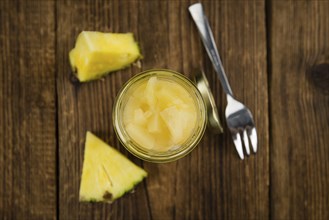 Fresh made Chopped Pineapple (preserved) on an old and rustic wooden table, selective focus,