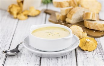 Portion of fresh Chanterelle Soup close-up shot, selective focus