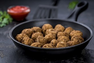 Slate slab with homemade Meatballs (selective focus, close-up shot)