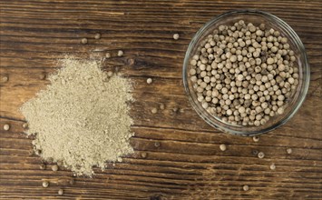 Fresh made White Pepper on a vintage background as detailed close-up shot