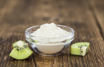 Fresh made Kiwi powder (slective focus, close-up shot) on an old wooden table