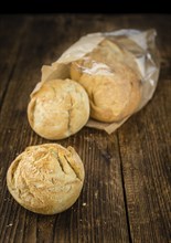 Fresh made German Buns on an old and rustic wooden table, selective focus, close-up shot