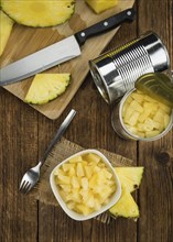 Preserved Pineapple pieces on a vintage background as detailed close-up shot, selective focus