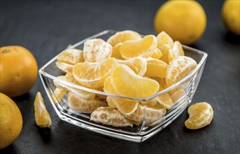 Fresh Tangerine pieces (selective focus) on a vintage background