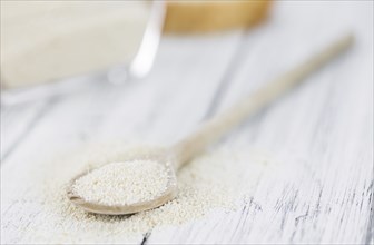 Some Bread Crumbs on a vintage wooden table (selective focus, close-up shot)