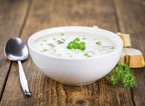 Homemade Porcini Soup on vintage background selective focus, close-up shot