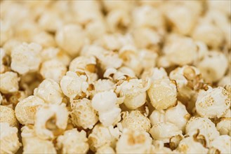 Fresh made Popcorn on a vintage background as detailed close-up shot