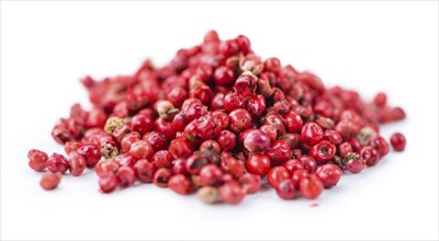 Portion of Pink Peppercorns as detailed close-up shot isolated on white background