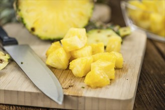 Fresh made Pineapple (sliced) on a vintage background as detailed close-up shot