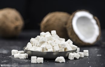 Portion of Coconut dices as detailed close-up shot, selective focus