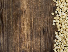 Fresh made Popcorn on an old and rustic wooden table, selective focus, close-up shot