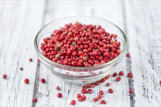 Pink Peppercorns on a vintage background as detailed close-up shot, selective focus