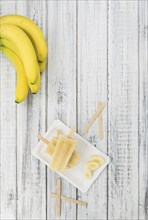 Banana Popsicles on vintage background as detailed close-up shot (selective focus)