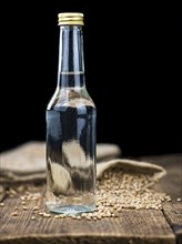 Vintage wooden table with Wheat Liqueur (selective focus, close-up shot)