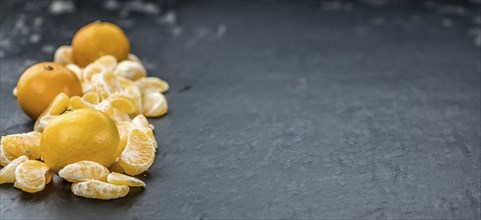 Fresh Tangerine pieces (selective focus) on a vintage background