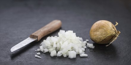 Diced white onions on a vintage background as detailed close-up shot, selective focus