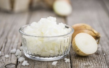 Diced white onions on a vintage background as detailed close-up shot, selective focus