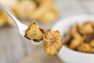 Fresh made Fried Chanterelles on a vintage background as detailed close-up shot