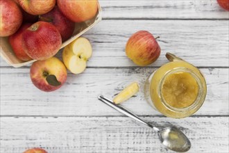 Portion of fresh made Applesauce (selective focus) on a wooden table