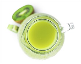 Fresh made Kiwi Smoothie isolated on white background (close-up shot, selective focus)