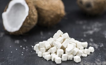 Portion of healthy Coconut dices (selective focus, close-up shot)