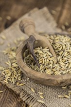 Wooden table with Oat (detailed close-up shot, selective focus)