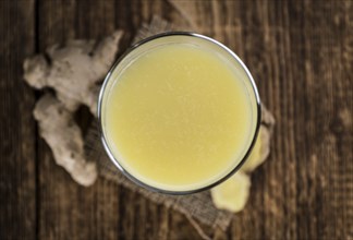 Portion of healthy Ginger Drink (selective focus, close-up shot)