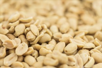 Roasted and salted Peanuts on vintage background (close-up shot, selective focus)