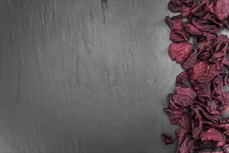 Beetroot Chips on a vintage looking slate slab (selective focus)