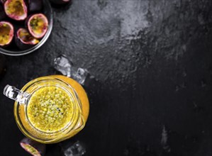 Maracuja Juice on a vintage looking slate slab (selective focus)