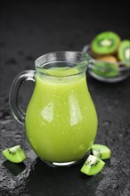 Kiwi Smoothie (selective focus) on an old and vintage background (homemade)