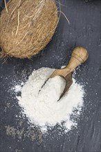 Some fresh made Coconut flour on a vintage slate slab (selective focus)