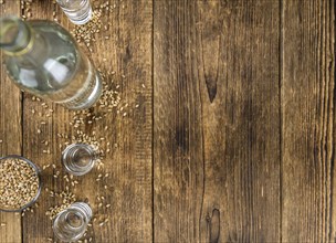 Vintage wooden table with Wheat Liqueur (selective focus, close-up shot)