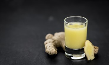 Portion of fresh Ginger Juice (selective focus, close-up shot)