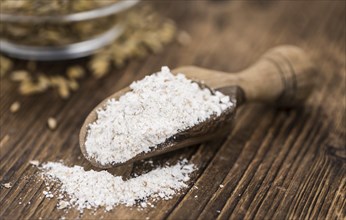 Vintage wooden table with Oat Flour (selective focus, close-up shot)