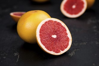 Grapefruits slices (selective focus) on a vintage background as detailed close-up shot