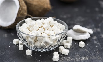 Portion of healthy Coconut dices (selective focus, close-up shot)