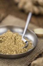 Portion of healthy Ground Ginger on an old wooden table (selective focus, close-up shot)