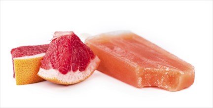 Portion of homemade Grapefruit Popsicles isolated on white background (selective focus)