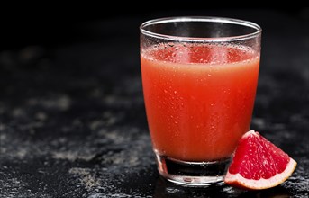 Slate slab with freshly squeezed Grapefruit Juice (selective focus, close-up shot)