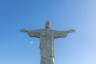 Christ the Redeemer statue in Rio de Janeiro, Brazil with blue sky in the background