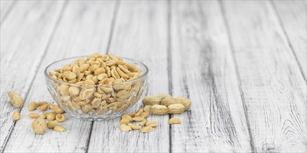 Portion of roasted and salted Peanuts (close-up shot, selective focus)