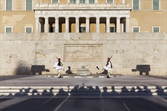 Two Evzones in traditional dress in front of the parliament building, Tomb of the Unknown Soldier,