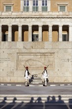 Two Evzones in traditional dress in front of the parliament building, Tomb of the Unknown Soldier,